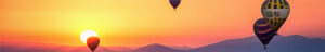 A sunset with hot air balloons