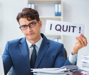 A man holding a sign that says "I quit."